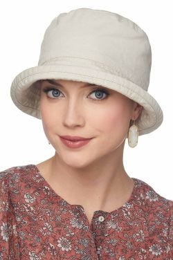 Woman in cotton khaki colored bucket hat for cancer patients