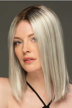Woman in a past the shoulders platinum blonde blunt cut wig
