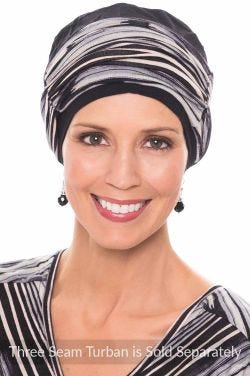 Woman in a black three seam turban with an oversized cinched bamboo headband on top