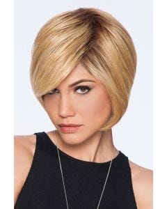 Woman in an angled reddish blonde chin length wig with side bangs