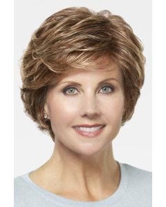 Woman in a short evenly layered red blonde bob wig with side bangs