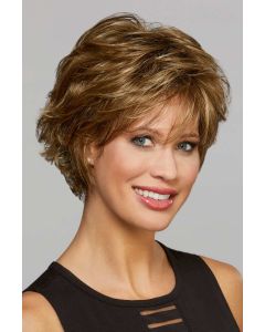 Woman in a long golden brown pixie wig with layers and wispy bangs