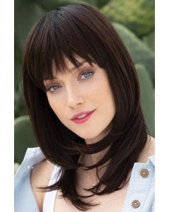 Woman in a past the shoulders dark brown wig with textured bangs and face framing layers