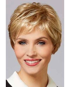 Woman in a close cropped classic pixie wig in light reddish blonde with short textured bangs