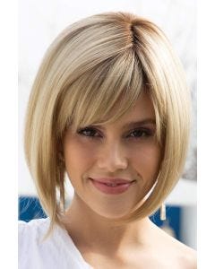 Woman in a chin length light blonde angled blunt bob wig with side fringe bangs
