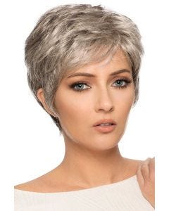 Woman in a light blonde classic pixie cut with short bangs