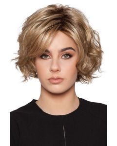 Woman in a chin length curly medium blonde layered bob wig