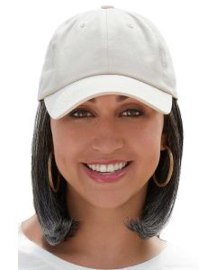 Woman in a solid beige baseball cap with shoulder length curled under light ash blonde hair attached