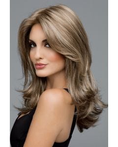 Woman in an extra long ash blonde wig with face framing and shoulder length layers