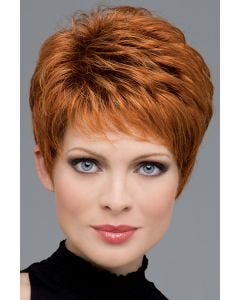 Woman in a copper red classic pixie wig with longer layers on top and fringe bangs