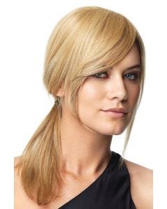 Woman with long face framing dark brown bangs attached to her biological hair
