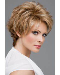 Woman in a warm blonde pixie wig with longer layers and side bangs on top