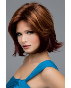 Woman in a medium auburn chin length flipped out bob wig with layering along the face