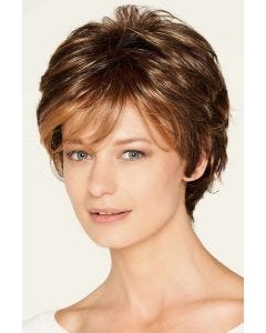 Woman in a medium auburn short wig with longer layers on the top and sides plus fringe bangs