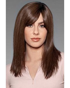 Woman in a large past the shoulders dark brown human hair wig with side bangs