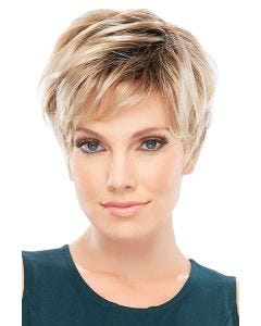 Woman in a tousled light blonde pixie wig with dark roots and long layers