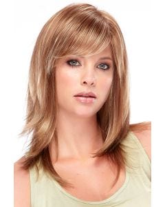 Woman in long light auburn wig with feathered layers and side swept bangs