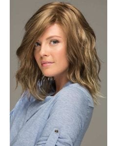 Woman in a shoulder length platinum blonde lace front wig with beach waves and dark roots