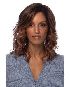 Woman in a shoulder length platinum blonde lace front wig with beach waves and dark roots