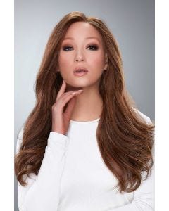 Woman in an extra long medium auburn human hair wig