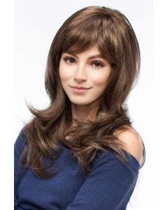 Woman in an extra long light brown wavy layered wig with side bangs