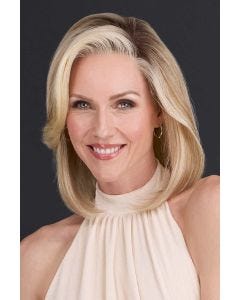 Woman in just past the shoulder wavy blonde wig with highlights and light layering