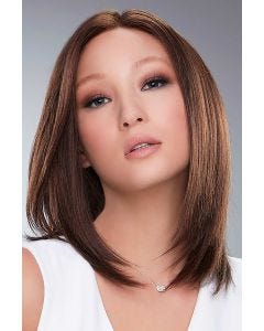 Woman in a past the shoulders medium auburn human hair wig with long layers