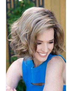 Woman in a chin length curly layered light blonde bob wig