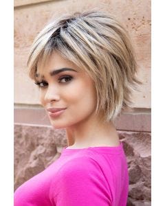 Woman in a shoulder length choppy light auburn bob wig with fringe bangs