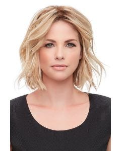 Woman in a wavy 12" light blonde human hair topper with an extra large base