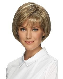 Woman in a chin length light brown rounded bob wig with textured bangs