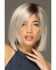 Woman in a shoulder length platinum blonde razor cut lace front wig