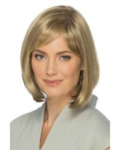 Woman in a past chin length light brown blunt bob with side curtain bangs