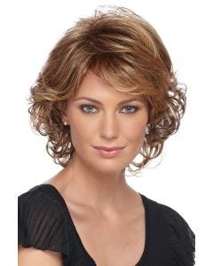 Woman in a short light auburn curly wig with side bangs