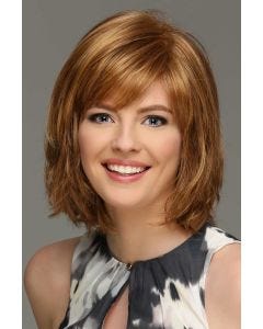 Woman in a chin length light auburn wig with side bangs