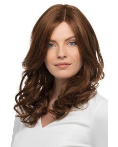 Woman in a past the shoulders curly medium auburn human hair wig