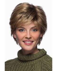 Woman in a short warm blonde layered wig with side bangs