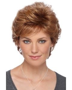 Woman in a short layered light auburn wig with side bangs