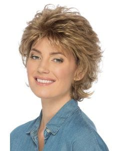 Woman in a volume infused short layered warm blonde wig