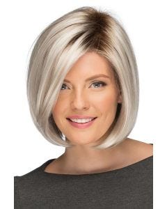 Woman in a chin length platinum blonde lace front wig with dark roots