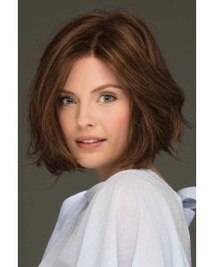 Woman in a chin length wavy medium auburn lace front bob wig