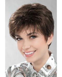 Woman in a long dark brown pixie wig with wispy bangs