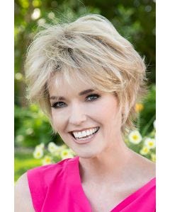 Woman in a short dark brown human hair wig with longer layers along the top and sides