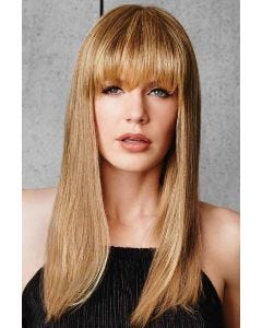 Woman in a long strawberry blonde hairpiece with bangs