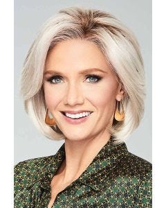 Woman in a chin length light blonde wig with long face framing layers