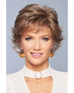 Woman in a flipped out brown grey short wig with wispy bangs