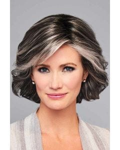 Woman in a chin length salt and pepper layered bob wig with side bangs