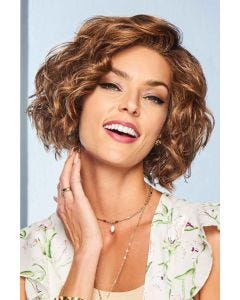 Woman in a chin length dark blonde curly bob lace front wig