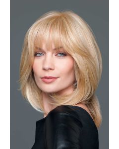 Woman in a warm blonde wiglet hair topper on the crown area