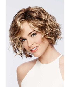 Woman in a chin length light brown curly lace front wig